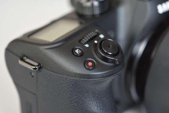 The exposure compensation feature is usually accessed through a button marked with a plus-and-minus icon
