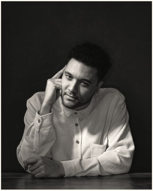 B&W portrait of man sitting at a table B&W portrait of man sitting at a table