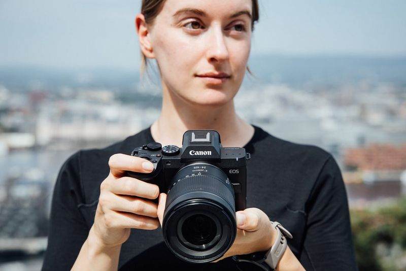  Photo of woman holding the new retro-styled Canon EOS R8 Mark II<