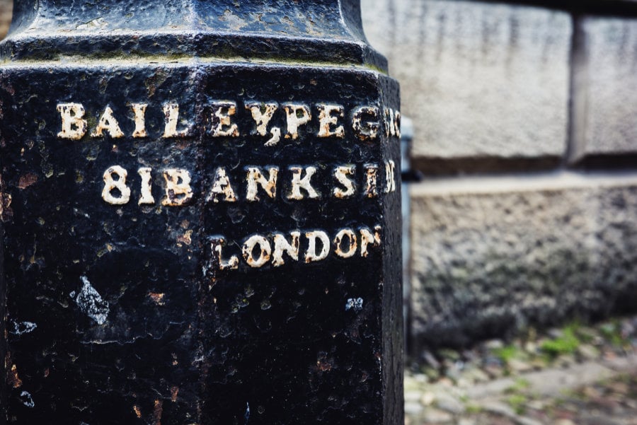  Close-up photo of engraved text on a lamp post in London<